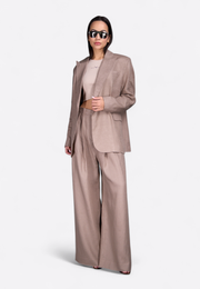 Front view of model wearing beige linen blazer, East Vibe